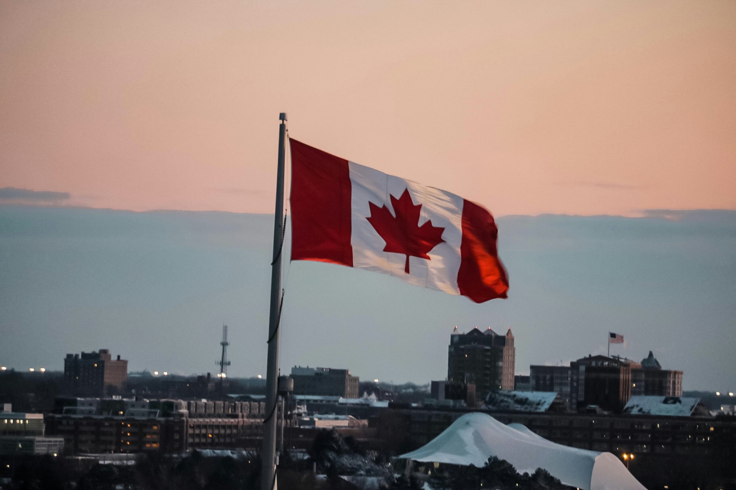 Cityscape with Canadian Flag Waving from Building Top